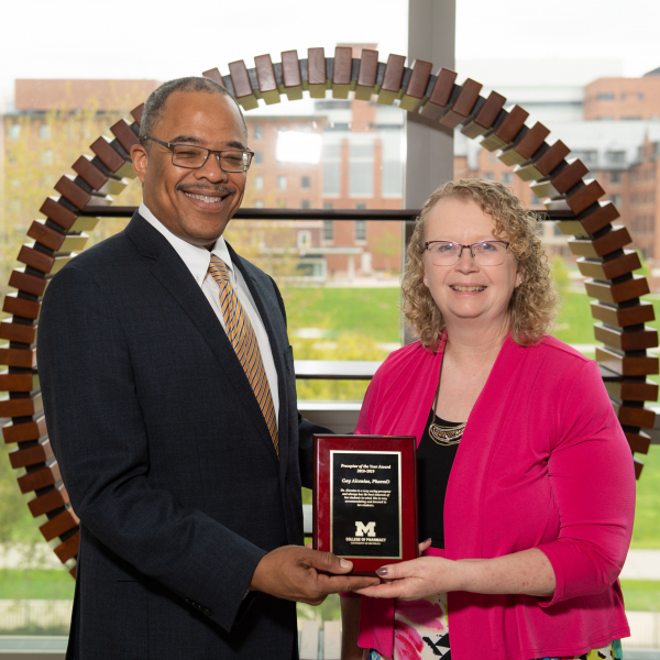 Dr. Paul Walker (left) presents the Preceptor of the Year award to Dr. Gay Alcenius 