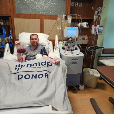 Dr. Daniel Hertz lying in a hospital bed during a stem cell donation.