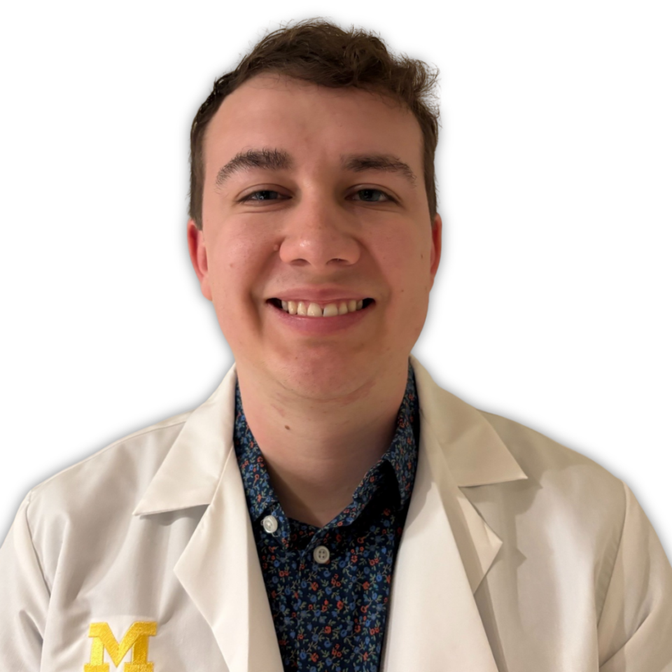 Benjamin Harvey, a preceptor award winner, poses for a photo in front of a white backdrop.