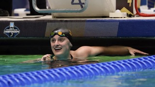 Female in a swimming pool competing in a race
