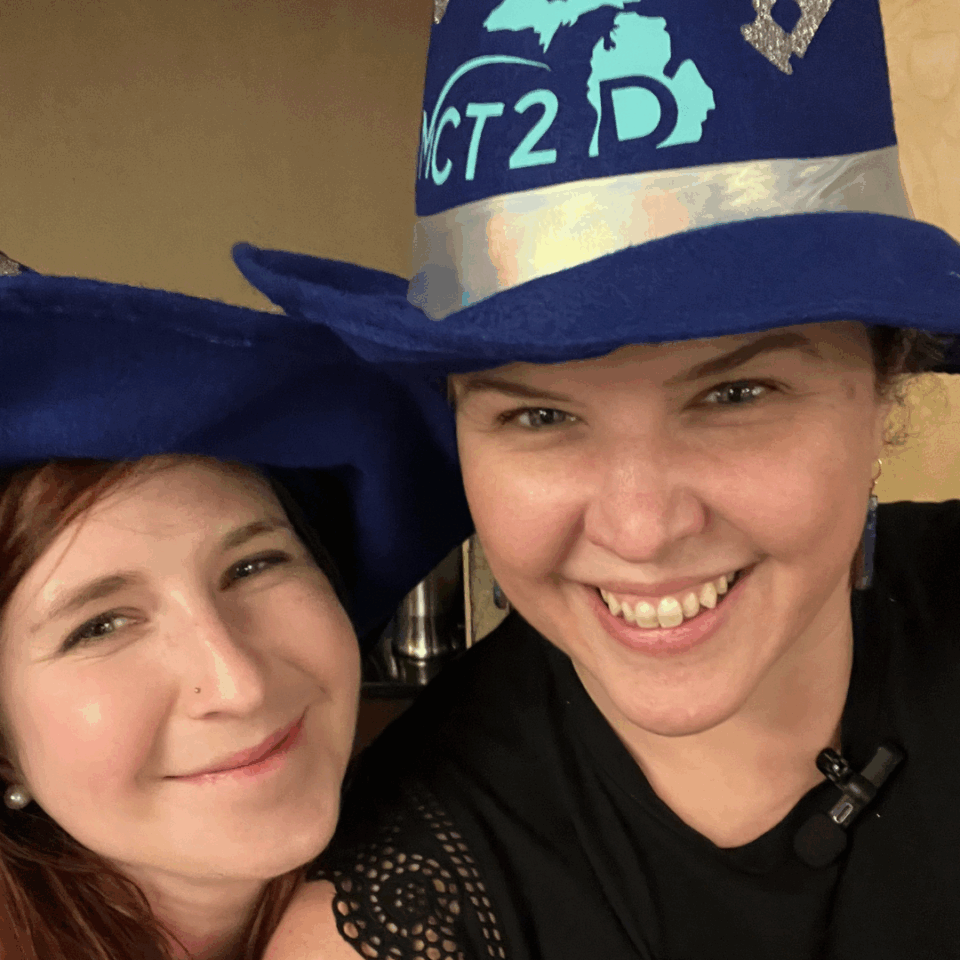 Larrea Young and Heidi Diez wearing wizard hats while leading a MCT2D Regional Meeting