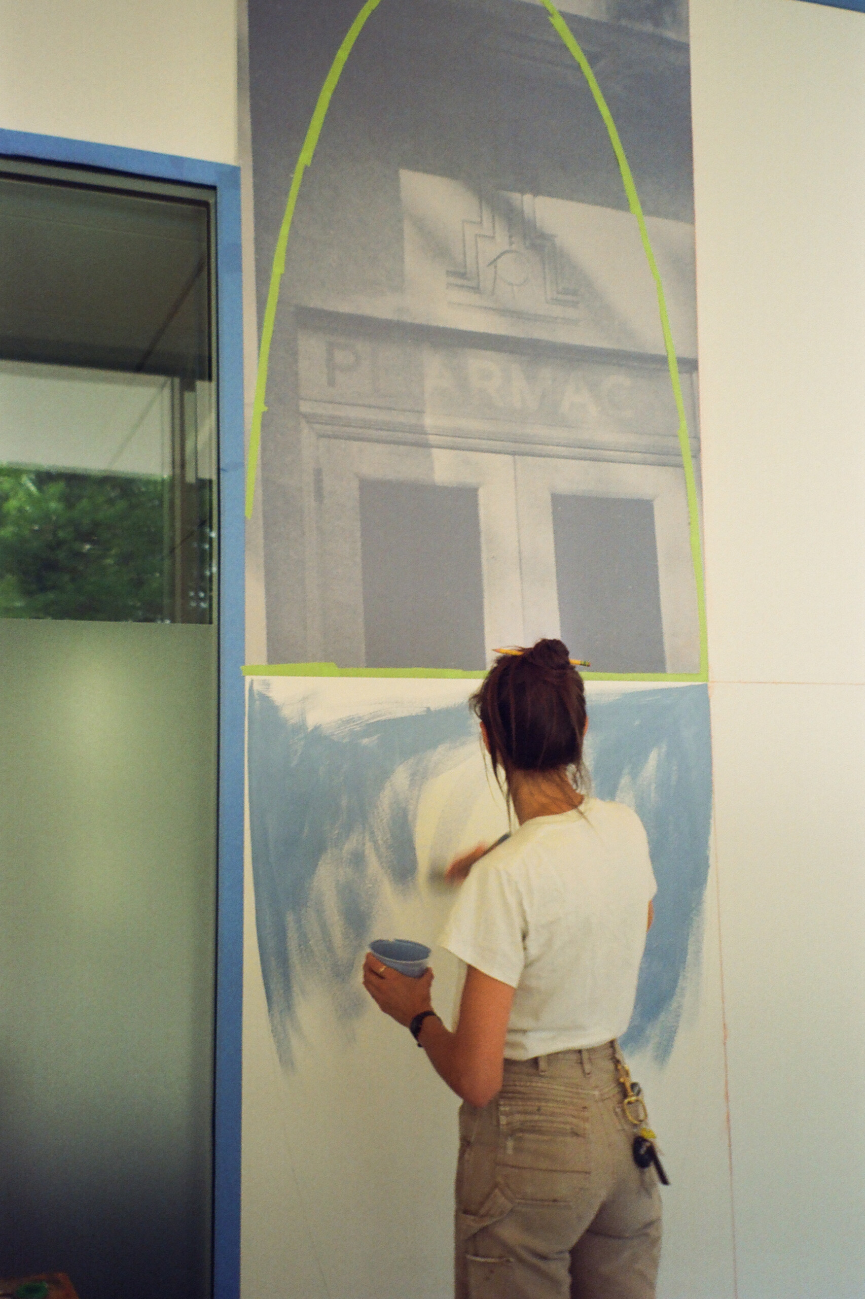 Ellen is painting a wall mural.