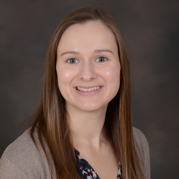 Woman posing in front of brown background